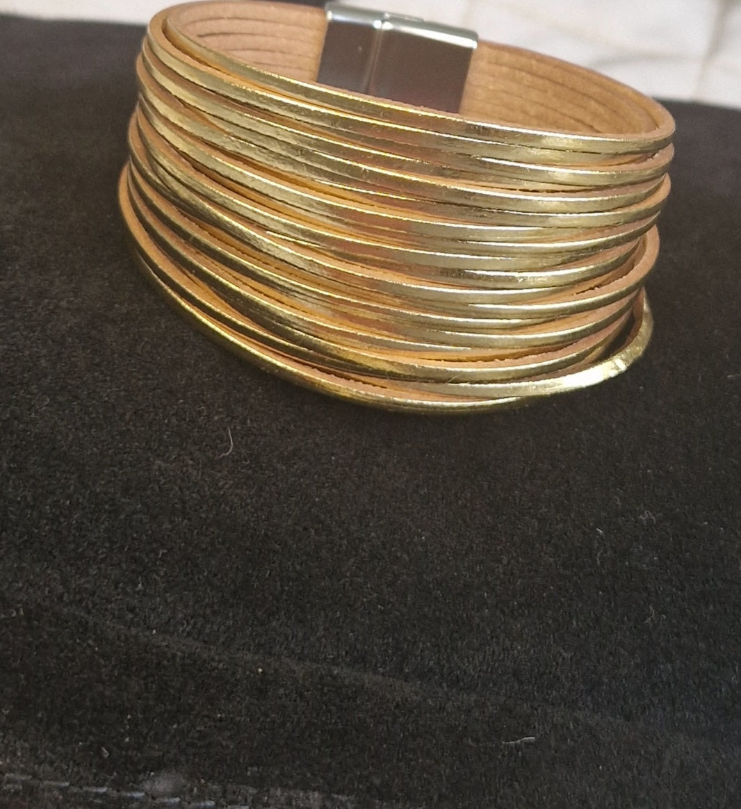 Gold layered faux leather bracelet.